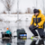 A man uses a WattCycle 12V 50Ah LiFePO4 battery for ice fishing