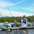 A man uses a WattCycle 12V 50Ah LiFePO4 battery to power his kayak for fishing